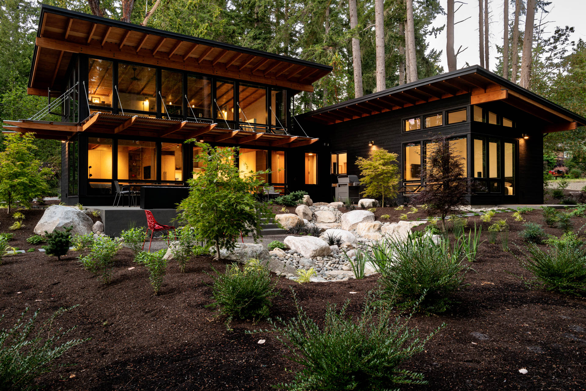 Image of Bainbridge Island House featuring Nakamoto Forestry's Gendai® and Pika-Pika® siding, with landscaping in the foreground